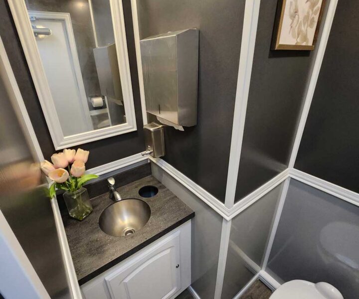 Cozy Cove Restroom Trailer Rentals 4-door luxury restroom rentals for events near me. The Four Seasons Restroom Trailer 4 stations interior photo.